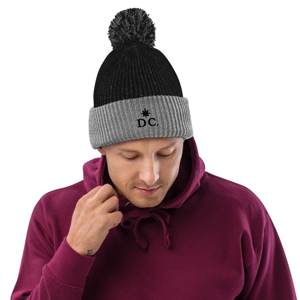 Black hat with top grey pom pom